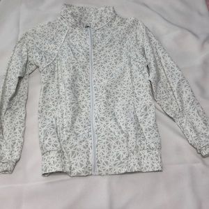 Grey and white geometric patterned wind breaker.